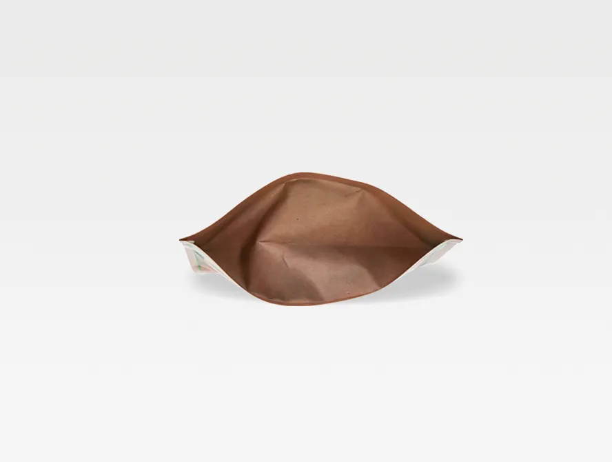 Side view of a kraft tea bag lying flat, showcasing gusset structure and natural texture
