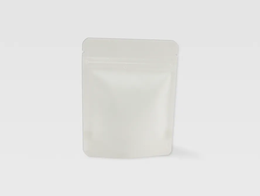Angled view of a white kraft pouch with ziplock seal and minimal green leaf logo