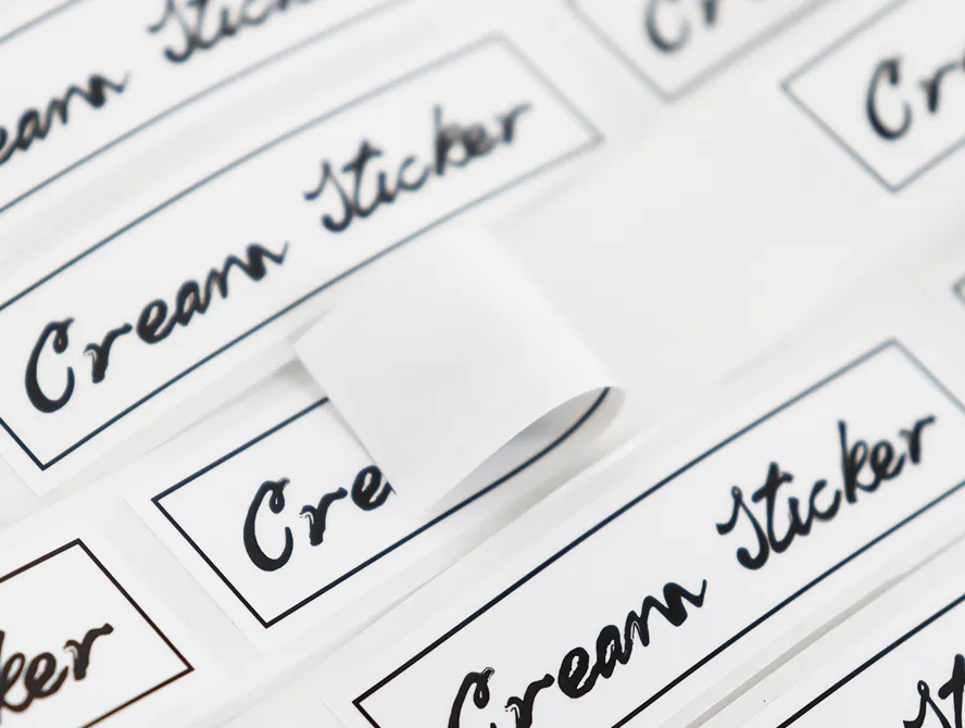 Close up of white face cream labels with script font