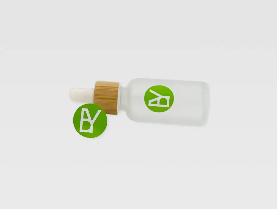 Round custom stickers applied to small dropper bottles