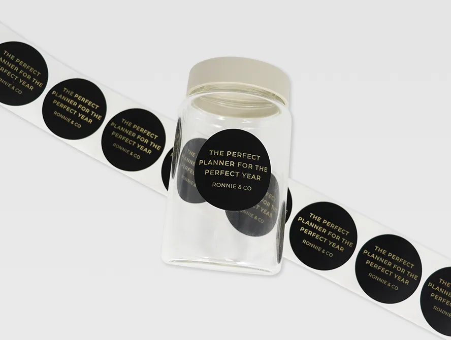 Gold foil label strip rolled out on surface