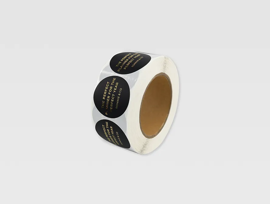 Custom gold foil label roll with black background