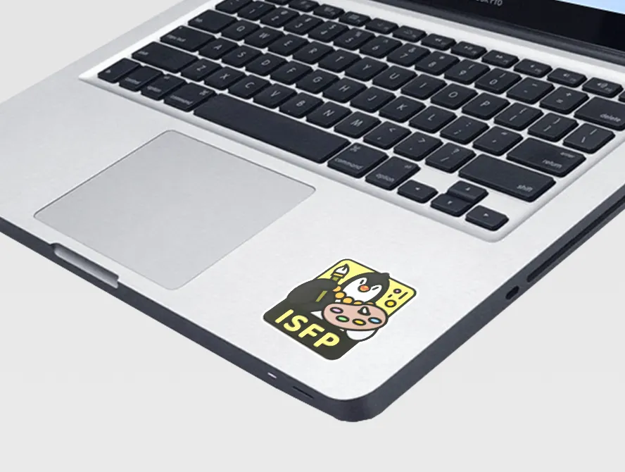 Laptop with a custom character sticker applied near the trackpad