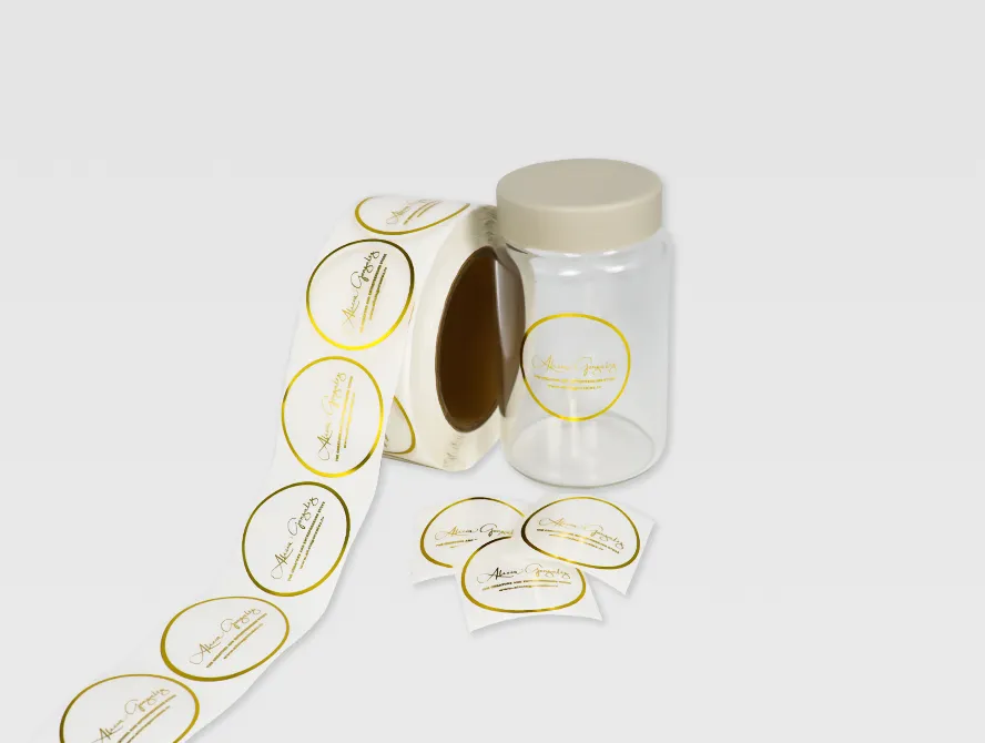 Unrolling gold foil transparent labels next to a glass jar