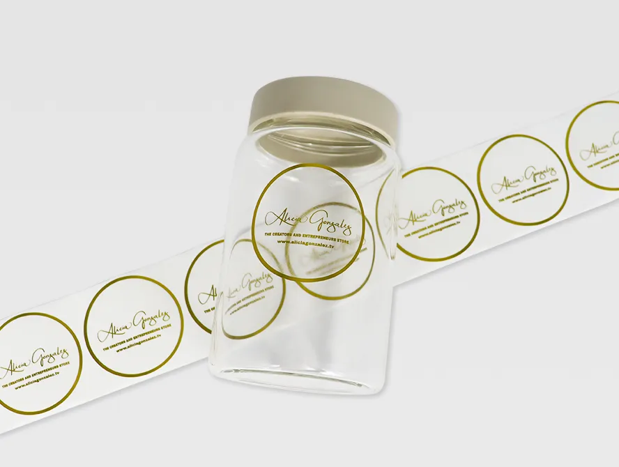 Close up of a strip of transparent labels with shiny gold foil accents