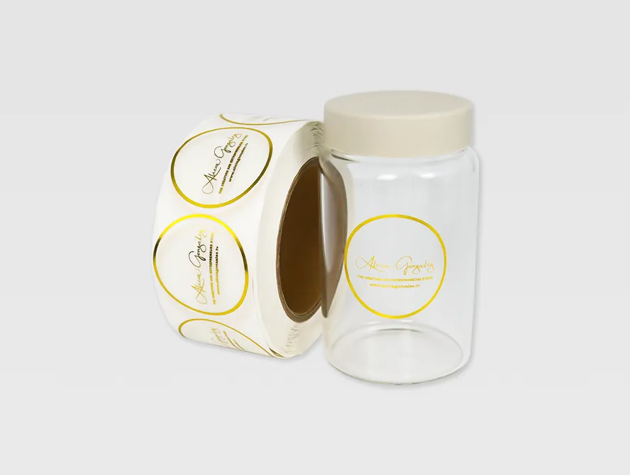 Roll of gold foil transparent labels displayed beside a labeled jar