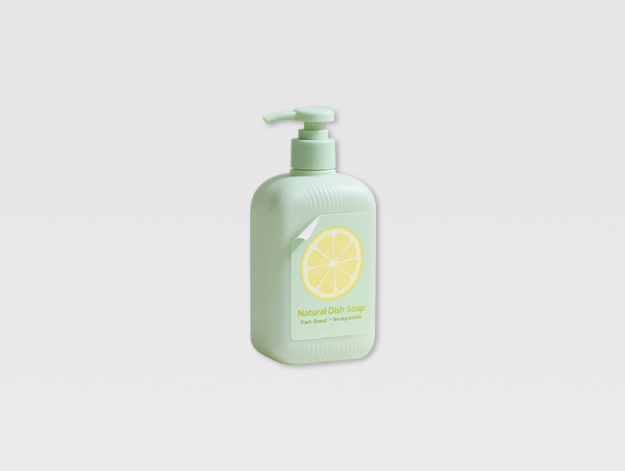 Green body wash bottle labeled with removable product sticker