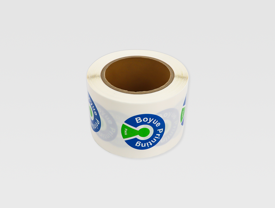Close up of printed logo sticker roll on white background
