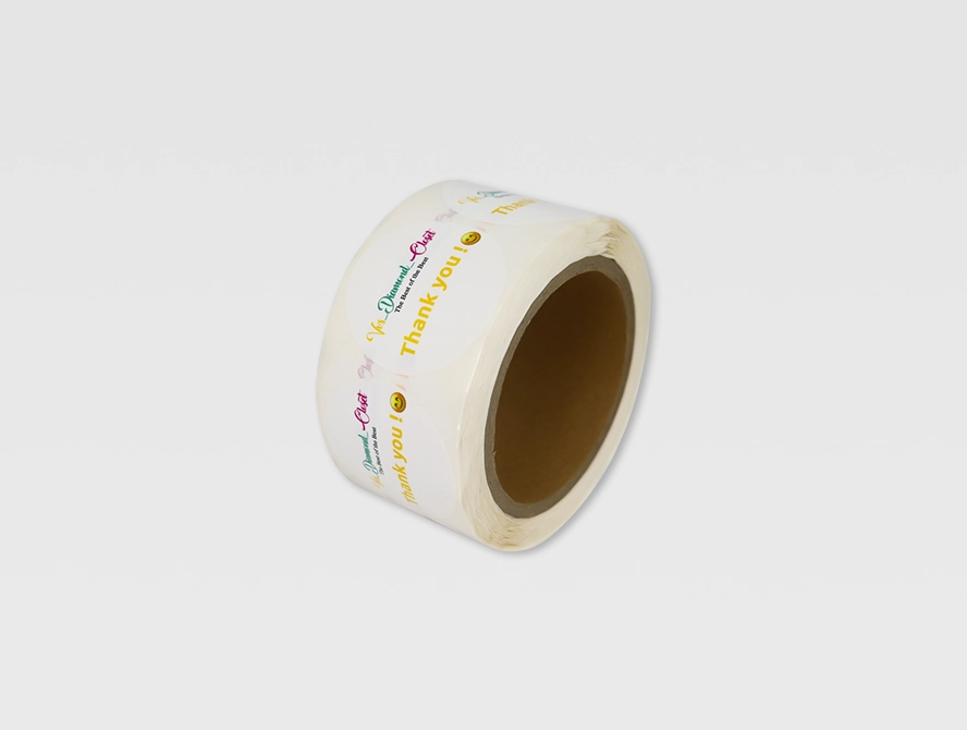 Roll of thank you stickers with rainbow text on white background