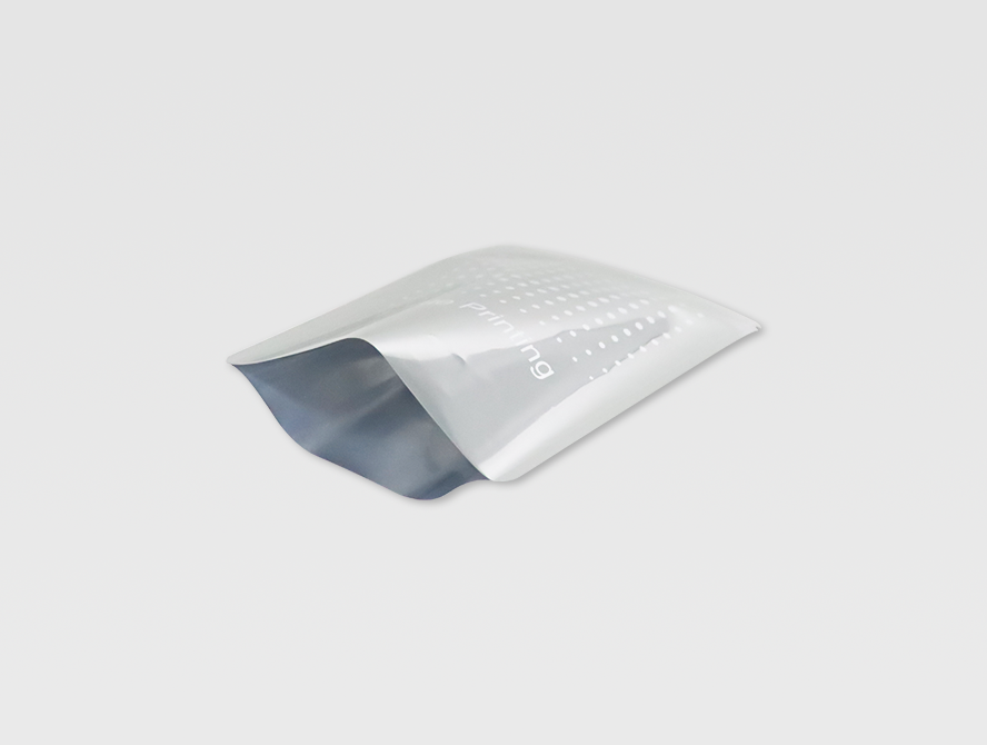 Open aluminum foil pouch with shiny inner lining and sealed edges