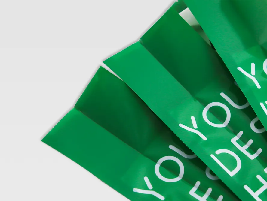 Multiple green rice pouches stacked diagonally with clear branding