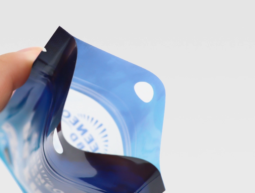 Hand holding open mylar pouch with zipper and window feature