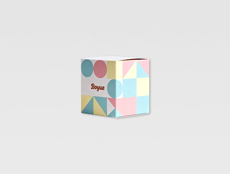Colorful abstract design on cube shaped candle packaging