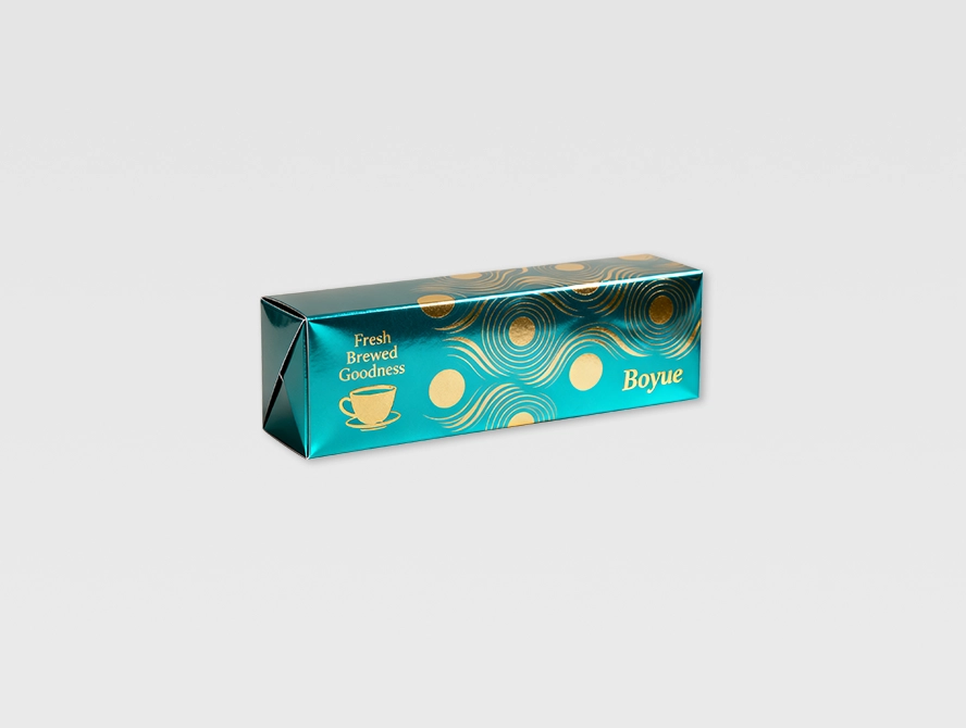 Teal tea box with floating tea leaves and floral accents