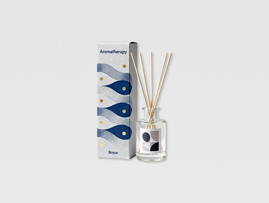 Blue reed diffuser box with ocean themed print and black reeds