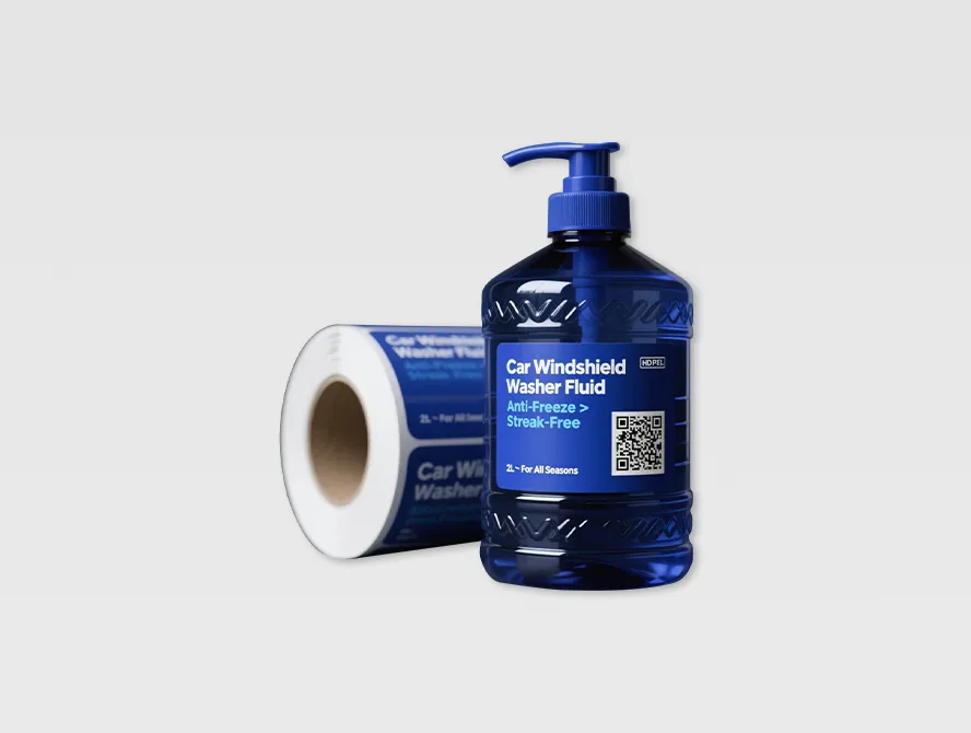 Blue shampoo bottle labeled with qr code sticker and sticker roll