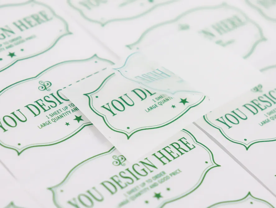 Flat lay of multiple green and white candle label stickers
